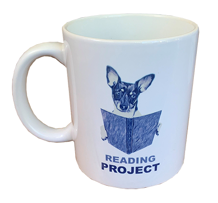 Front of Reading Project mug showing icon of Lucy the dog reading a book