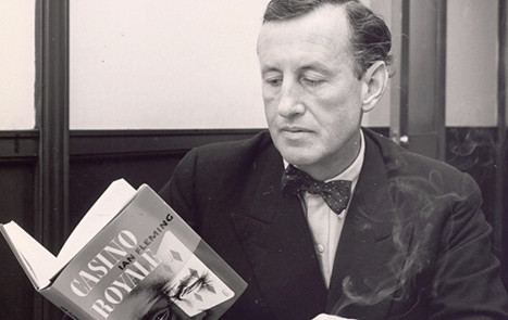 Ian Fleming reading a copy of Casino Royale