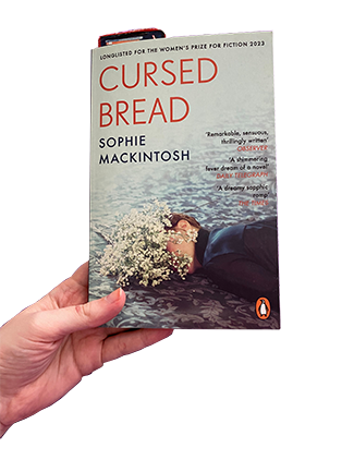Holding my copy of Cursed Bread