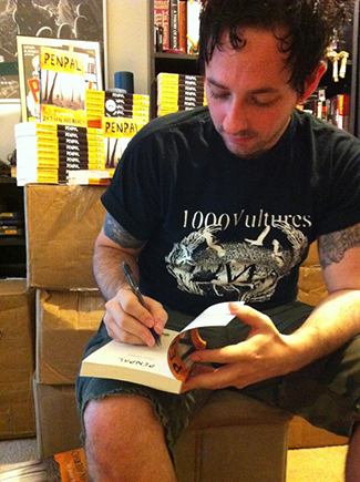 Dathan Auerback signing copies of his novel Penpal