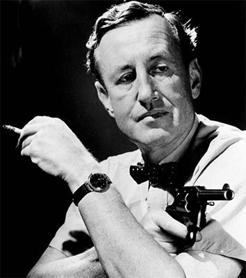 Ian Fleming pointing a pistol