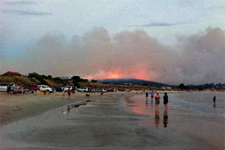 Residents of Primrose Sands, Tasmania, take refuge on their beach from a bushfire